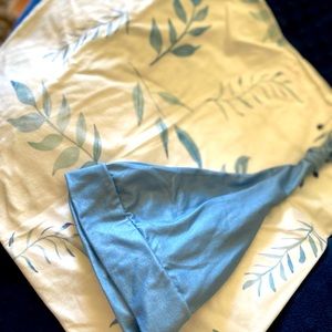 Swaddled with matching hat.